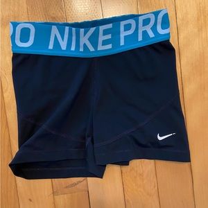 Black Nike pros with turquoise waist band